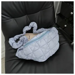 Elegant light blue quilted fanny pack with a stylish cloud-like pleated strap.