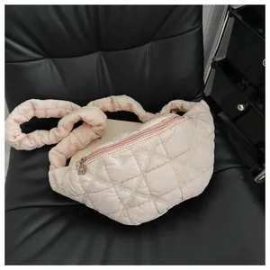 Detailed close-up of a stylish pink quilted chest bag with a ruffled shoulder strap.