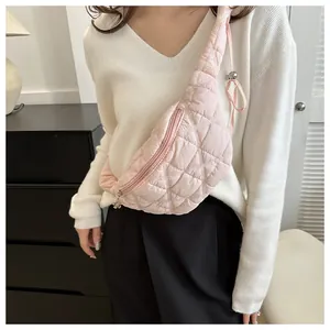 Detailed view of fashionable quilted pink chest bag worn as a crossbody accessory