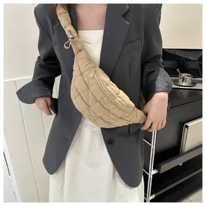 Stylish khaki quilted cross-body chest bag with floral zipper pull detail on model