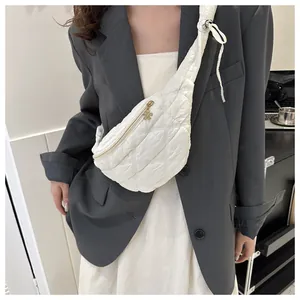 White quilted chest bag with a stylish diamond pattern and flower zipper pull on a model