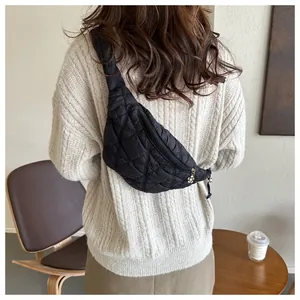 Stylish black quilted fanny pack for women worn as a crossbody bag on the back