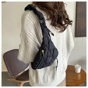 Stylish black quilted chest bag with elegant ruffled shoulder strap worn by model