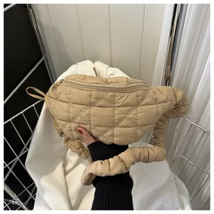 Detailed view of a stylish beige quilted fanny pack featuring a textured ruffled strap.