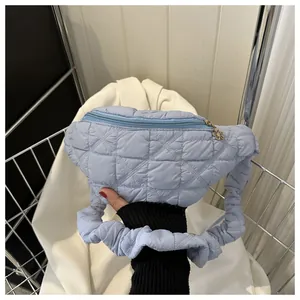 Stylish light blue quilted fanny pack with elegant ruffled shoulder strap detail