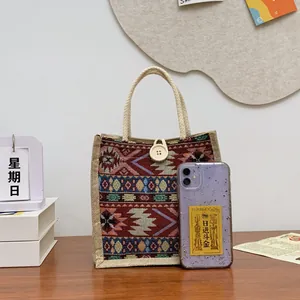 Ethnic pattern woven tote bag with rope handle shown next to a smartphone for scale