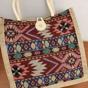 Detail of ethnic style woven tote bag with colorful tribal patterns and wooden button