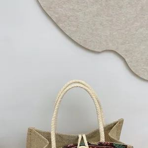 Close-up detail of ethnic style woven tote bag featuring durable braided rope handles