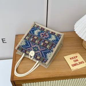 Close-up of ethnic style tote bag with colorful geometric patterns and rope handle
