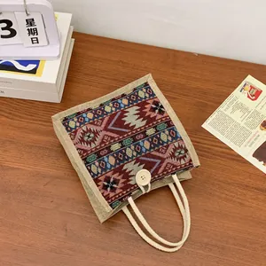 Ethnic style woven tote bag with colorful geometric patterns and rope handles