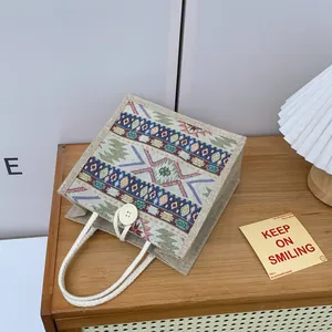 Close-up detail of ethnic Tibetan pattern tote bag with rope handle and button closure