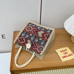 Detailed view of an ethnic woven jute tote bag with tribal patterns and button