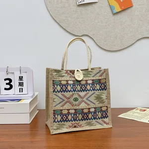 Ethnic style woven tote bag with tribal patterns and white button closure detail.