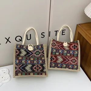 Detailed view of two ethnic style woven tote bags with geometric tribal patterns.