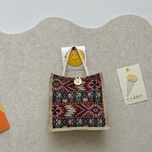 Ethnic style tote bag with tribal geometric patterns and cotton rope handles.