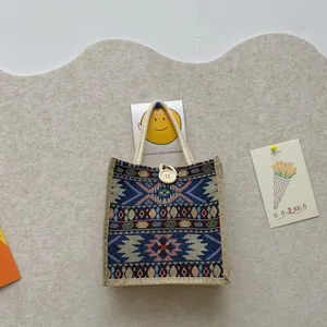 Handmade ethnic woven tote bag with vibrant tribal patterns and wooden button detail