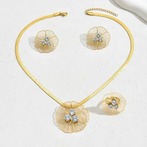Detailed macro shot of gold-plated floral jewelry set featuring clear cubic zirconia