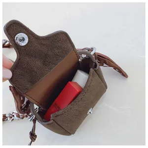 Detailed interior view of vintage brown suede mini purse showing capacity and silk scarf
