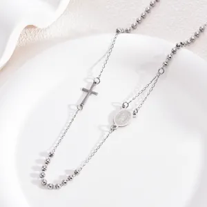 Detailed close-up of a stainless steel 3mm rosary necklace with cross and holy medal