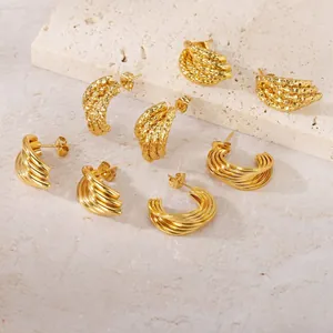Vue détaillée de boucles d'oreilles en acier titane doré aux motifs géométriques