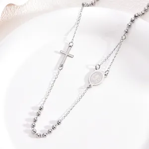 Detail view of a 3mm stainless steel rosary necklace with cross and Virgin Mary charms.
