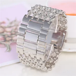 Detail of women's quartz watch with wide silver bracelet band and rhinestone mesh design