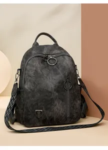 Close-up of vintage grey washed fabric backpack with geometric patterned strap.