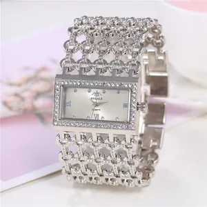 Detail of silver square quartz watch with full crystal studded wide bracelet band