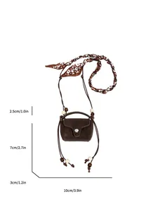 Close-up of a vintage brown suede mini crossbody purse with measurement annotations