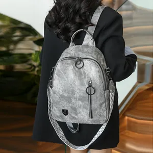 Stylish vintage grey women's backpack with washed leather texture and woven shoulder strap