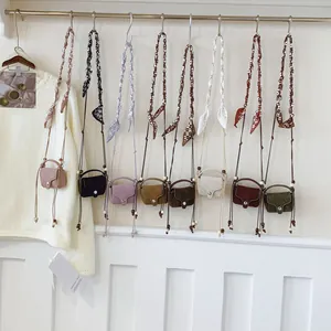 Vintage style suede mini crossbody coin bags with decorative braided scarf straps