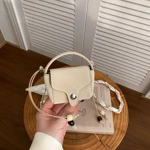 Vintage style beige suede mini crossbody coin purse with delicate cord strap and beads
