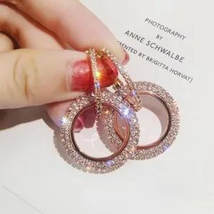 Detailed macro view of sparkling rose gold hoop earrings encrusted with micro-pave crystals
