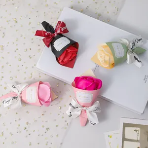 Detailed view of various mini soap rose bouquets in pink, red and yellow with gift ribbons
