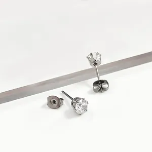 Detailed macro view of minimalist round clear cz stud earrings in silver tone
