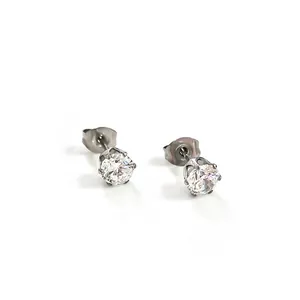 Detailed macro view of minimalist round cubic zirconia stud earrings with silver setting