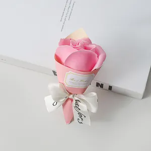 Detailed view of pink soap rose bouquet with Best Wishes label and white ribbon
