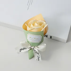 Close-up of a mini cream soap rose bouquet with a decorative ribbon bow