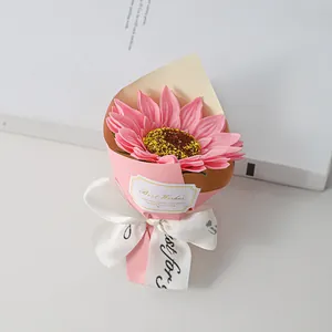Detail of a pink soap sunflower mini bouquet with elegant white ribbon and Best Wishes tag