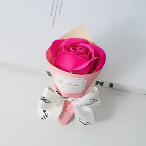 Detailed view of mini soap rose bouquet with pink wrap and Best Wishes tag