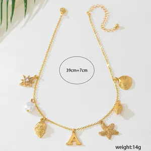 Detailed view of ocean themed gold necklace featuring shell, starfish, and pearl charms