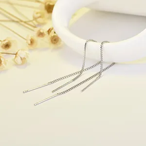 Detail of minimalist S925 sterling silver box chain ear threads on white background