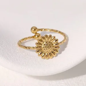 Detailed close-up of a gold-plated stainless steel sunflower ring with a hammered band.