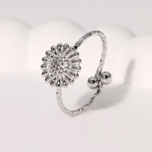 Detailed view of silver stainless steel daisy ring with adjustable textured band