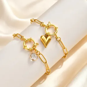 Detail view of 18K gold plated stainless steel heart and zircon charm bracelets