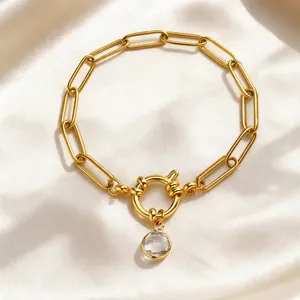 Detailed view of 18K gold plated paperclip bracelet with bubble clasp and zircon
