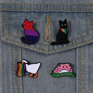 Set of creative cartoon animal enamel pins featuring pride cats and a goose on denim