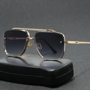 Close-up detail of stylish oversized metal aviator sunglasses with gradient dark lenses.