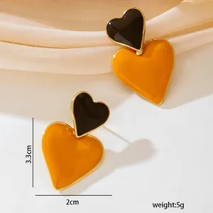 Detail view of fashion heart enamel stud earrings showing 3.3cm height and 5g weight