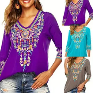 Detail view of retro V-neck embroidered blouse in purple, teal and grey